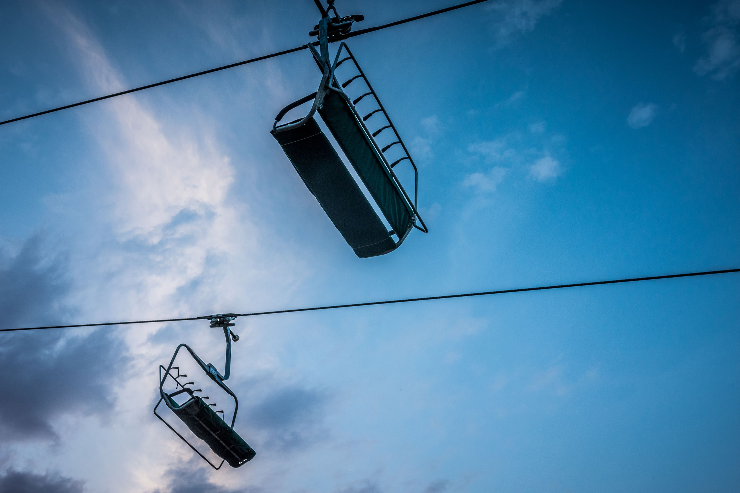 Chair lift at a ski resort in the mountains in the summer at sun